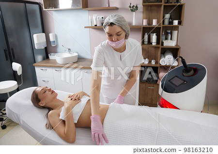 Before Endosphere therapy of female body by cosmetologist in beauty salon Before Endosphere therapy of female body by cosmetologist in beauty salon 98163210