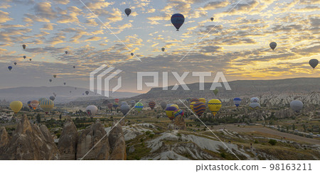 hot air balloon flies in the sky at dawn 98163211