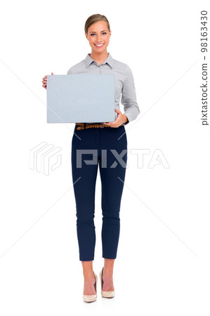 Shes the leader in her profession. Full-length studio shot of an attractive young businesswoman holding a blank sign. 98163430