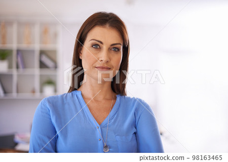 Creative and professional. A confident businesswoman standing in her office. Creative and professional. A confident businesswoman standing in her office. 98163465