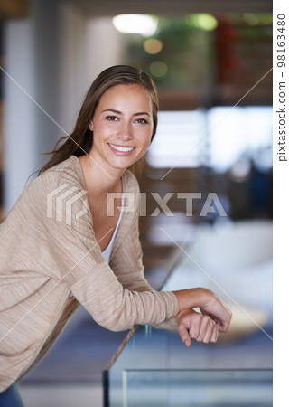 Enjoying a me-day today. Shot of an attractive young woman relaxing at home. 98163480