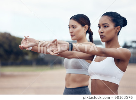 Fitness, stretching and diversity women focus on sports exercise, marathon training or health workout in outdoor park. Wellness, performance start and girl friends with healthy mindset working on arm Fitness, stretching and diversity women focus on sports exercise, marathon training or health workout in outdoor park. Wellness, performance start and girl friends with healthy mindset working on arm 98163576