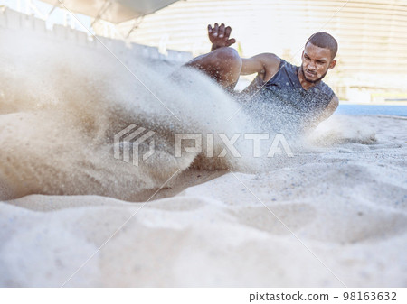 Man, athlete and sand for long jump, sport and training for sports, field and global competition. Sport, motivation and goal for podium, winning and world record for jumping at arena, stadium or park 98163632