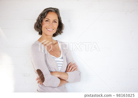 Im a will be not a has-been. A beautiful mature woman crossing her arms while standing ina studio. 98163825