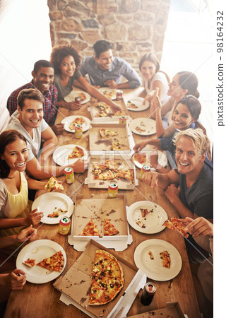 Friends, portrait and pizza party, table and happy smile with diversity, social and celebration at a restaurant. Happiness people, fast food and social event while eating, celebrate and friendship Friends, portrait and pizza party, table and happy smile with diversity, social and celebration at a restaurant. Happiness people, fast food and social event while eating, celebrate and friendship 98164232