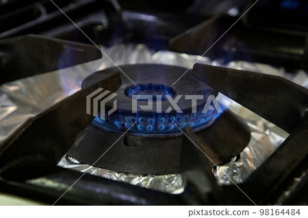 Stoves. Kitchen room. Gas stove with burning propane gas flames. Concept of industrial resources and economy. Stoves. Kitchen room. Gas stove with burning propane gas flames. Concept of industrial resources and economy. 98164484