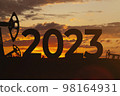 Oil production against backdrop of beautiful sunset. 2023 and oil fields.  98164931