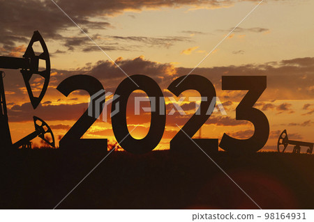 Oil production against backdrop of beautiful sunset. 2023 and oil fields. Oil production against backdrop of beautiful sunset. 2023 and oil fields. 98164931
