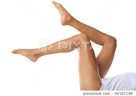 Legs, beauty and skincare with a model black woman posing in studio on a white background for skin treatment. Fitness, spa and feet with a female isolated indoors for natural care or luxury wellness Legs, beauty and skincare with a model black woman posing in studio on a white background for skin treatment. Fitness, spa and feet with a female isolated indoors for natural care or luxury wellness 98165196