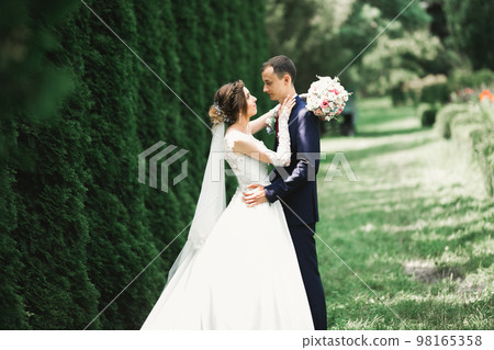 Gorgeous happy couple standing close to each other and looking in eyes 98165358