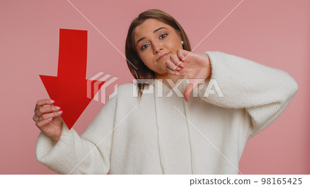 Upset young woman showing red arrow pointing down, concept of downgrade bankruptcy money fail, fall 98165425