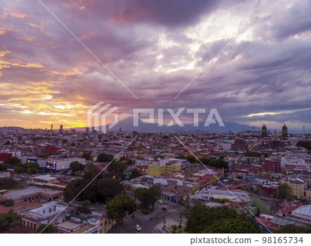 Puebla at Dramatic evening Sunset aerial drone shot of City Center in Puebla de Zaragoza, Puebla State, Mexico Puebla at Dramatic evening Sunset aerial drone shot of City Center in Puebla de Zaragoza, Puebla State, Mexico 98165734