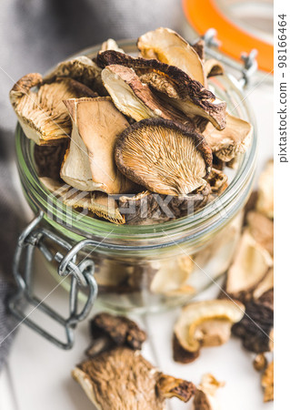 Sliced dried mushrooms in jar. Sliced dried mushrooms in jar. 98166464
