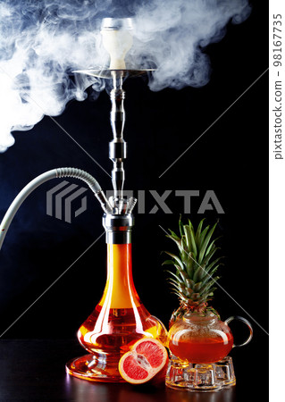Modern shisha and glass teapot on black background Modern shisha and glass teapot on black background 98167735