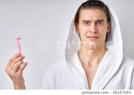 caucasian man isolated. Portrait of strong muscular man with razor standing on white 98167844