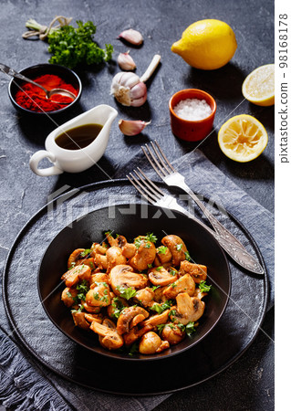 Spanish Garlic Mushrooms in bowl, top view Spanish Garlic Mushrooms in bowl, top view 98168178