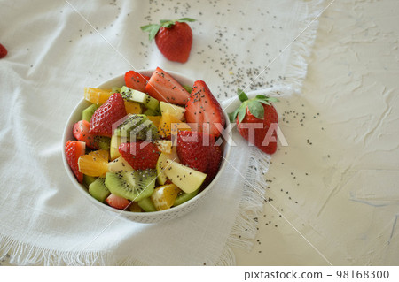 Bowl of fresh fruit salad, kiwi, apples, oranges. Bowl of fresh fruit salad, kiwi, apples, oranges. 98168300