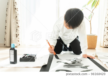 Japanese elementary school boy writing kakizome 98168420