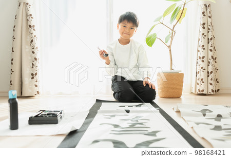 Japanese elementary school boy writing kakizome 98168421