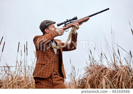 Confident caucasian hunter. American hunting rifles. Hunting