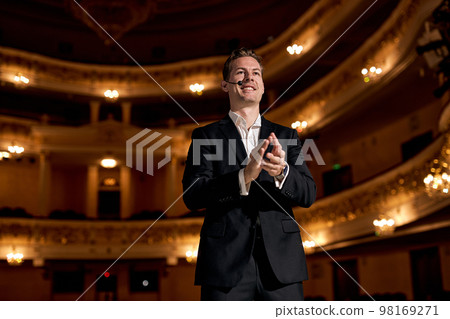 guy of american appearance in formal classic suit clapping hands after giving speech guy of american appearance in formal classic suit clapping hands after giving speech 98169271
