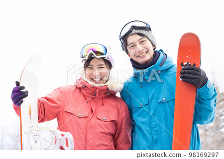 Couple enjoying the snowy mountains Couple enjoying the snowy mountains 98169297