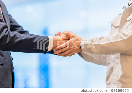 Businessman and engineer shaking hands faceless Businessman and engineer shaking hands faceless 98169923