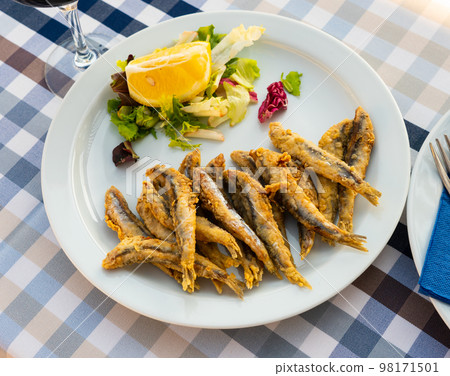 Dish with fried sardines, pilchards or anchovies in batter for traditional Spanish meal Dish with fried sardines, pilchards or anchovies in batter for traditional Spanish meal 98171501