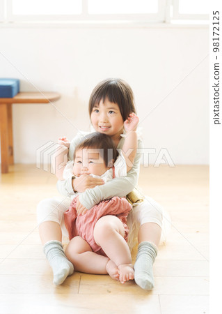 sisters playing indoors sisters playing indoors 98172125