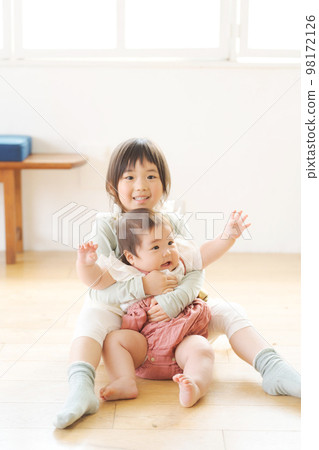 sisters playing indoors sisters playing indoors 98172126