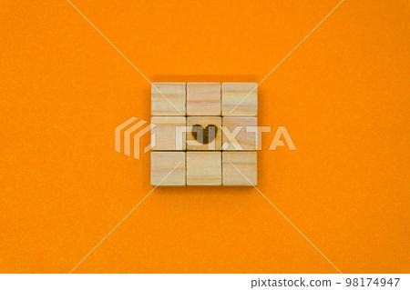 A puzzle of 9 wooden cubes with a heart symbol in the center A puzzle of 9 wooden cubes with a heart symbol in the center 98174947