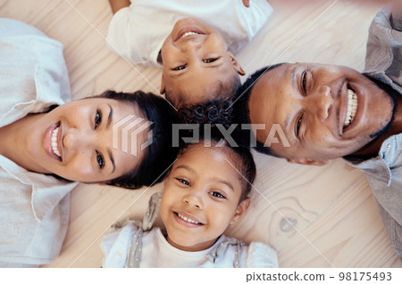 Happy, smile and portrait of family on floor with top view for bonding, support or relax in living room. Funny, playing and affection with face of parents and children on ground at home for happiness 98175493