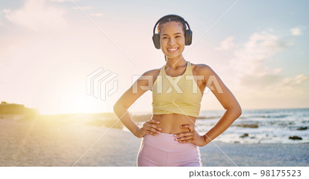 Fitness, exercise and portrait of woman at the beach in morning for healthy lifestyle, wellness and cardio. Sports, nature and happy woman ready for training, running and workout with headphones 98175523