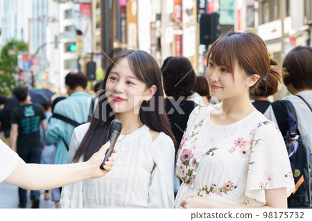 A woman undergoing a street interview A woman undergoing a street interview 98175732
