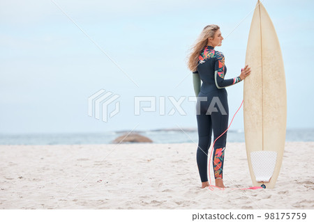 Woman, surfer and board on the beach for sports exercise, training and hobby in the summer outdoors. Professional female standing with surfboard on mockup by a ocean for sport surfing in South Africa 98175759