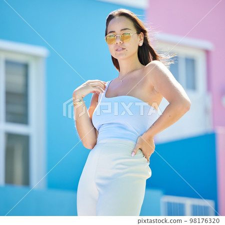 Beauty, fashion and city with a model woman outdoor on a color background in Bokaap, Cape Town, South Africa. Street, summer and portrait with an attractive young female posing in an urban town Beauty, fashion and city with a model woman outdoor on a color background in Bokaap, Cape Town, South Africa. Street, summer and portrait with an attractive young female posing in an urban town 98176320