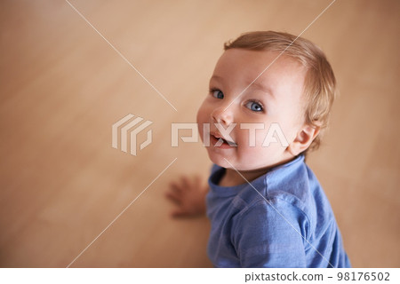 The cutest smile. An adorable infant looking up at the camera. The cutest smile. An adorable infant looking up at the camera. 98176502