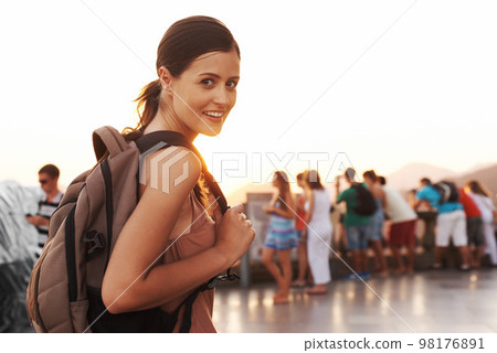 Exploring a new city. Portrait of a young woman holding a backpack. Exploring a new city. Portrait of a young woman holding a backpack. 98176891