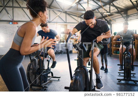 Cycle spinning, fitness and applause of a coach with motivation for cycling gym training. Sports coach clapping for workout, wellness and bike exercise success of people on bicycle happy from cardio 98177152