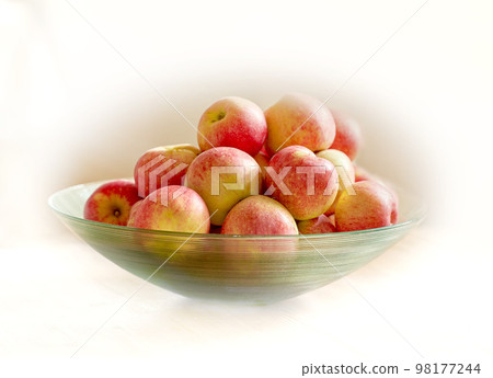 An apple per day keeps the doctor away. Glass bowl with lots of healthy apples - a really healthy and tempting treat. An apple per day keeps the doctor away. Glass bowl with lots of healthy apples - a really healthy and tempting treat. 98177244