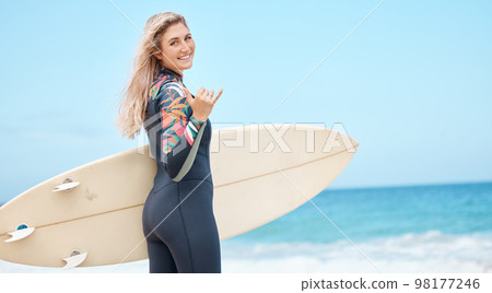 Ocean, woman and portrait with surfer hand in Hawaii for water recreation break with blue sky. Young and happy surfing girl enjoying beach leisure with surfboard for summer holiday in Honolulu. Ocean, woman and portrait with surfer hand in Hawaii for water recreation break with blue sky. Young and happy surfing girl enjoying beach leisure with surfboard for summer holiday in Honolulu. 98177246