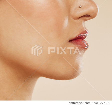 Mouth, lipstick and woman in studio for beauty, skincare and dermatology wellness. Zoom face of a young model with lips care, gloss and cosmetics makeup for healthy glow, botox or plastic surgery 98177322