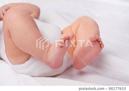 His footsteps will need guidance. a baby boys legs and feet in a studio. His footsteps will need guidance. a baby boys legs and feet in a studio. 98177633