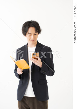 A man in his twenties in a jacket A man in his twenties in a jacket 98177659