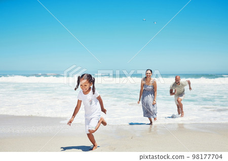 Summer, travel and family running at beach for vacation, freedom and happy together. Holiday, fun and wellness with parents playing with girl in ocean water for health, energy and youth lifestyle Summer, travel and family running at beach for vacation, freedom and happy together. Holiday, fun and wellness with parents playing with girl in ocean water for health, energy and youth lifestyle 98177704
