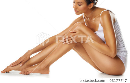 Woman, legs and skincare for beauty, studio and isolated on white background. Female model, laser hair removal and leg cosmetics for body, wellness and epilation of aesthetic results, shine and salon 98177747