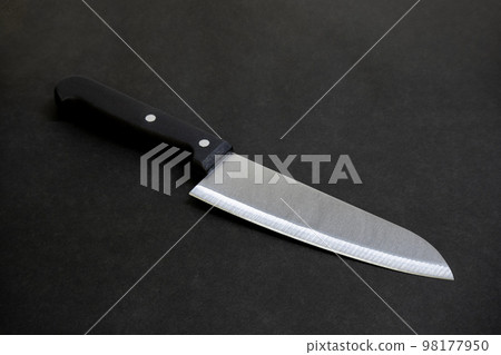 Image of a kitchen knife with the blade in front on a black background 98177950