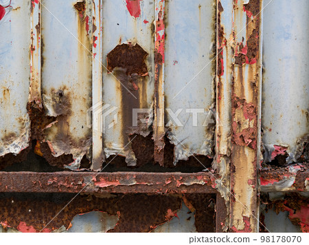 wall or surface of a fence of metal, with orange grooves from rust and irregular chipping. wall or surface of a fence of metal, with orange grooves from rust and irregular chipping. 98178070