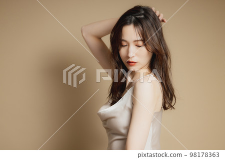 A woman in a beige dress 98178363