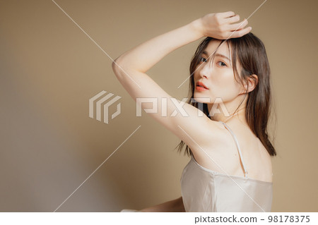 A woman in a beige dress A woman in a beige dress 98178375